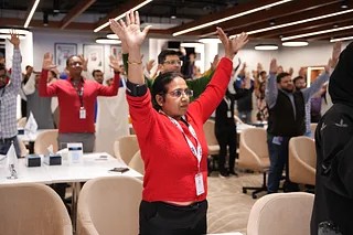 Participants in an energizing icebreaker exercise during a corporate workshop